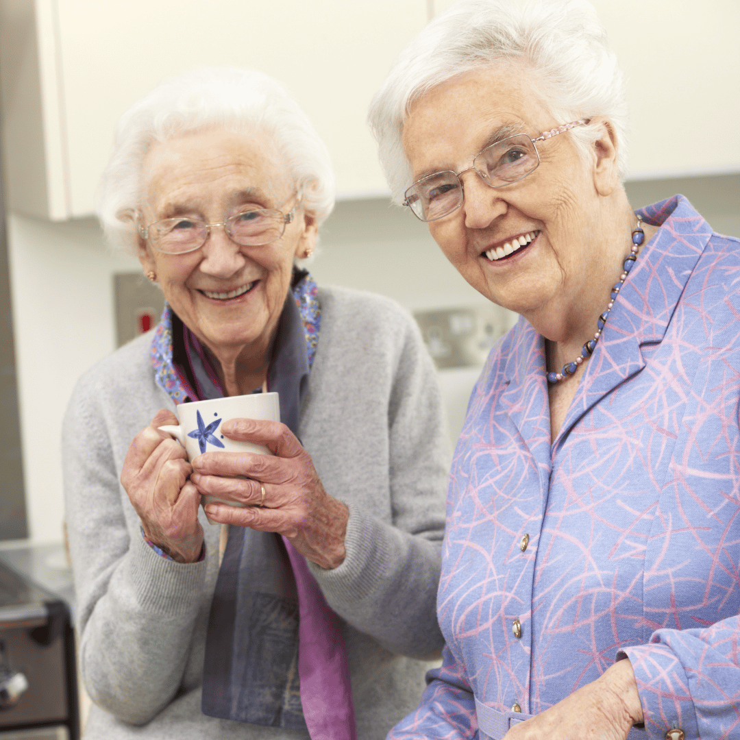 2 women drinking tea and smiling
